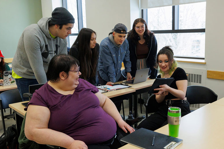 Eileen Lennie-Koshman sits with fellow ISAP students in a classroom